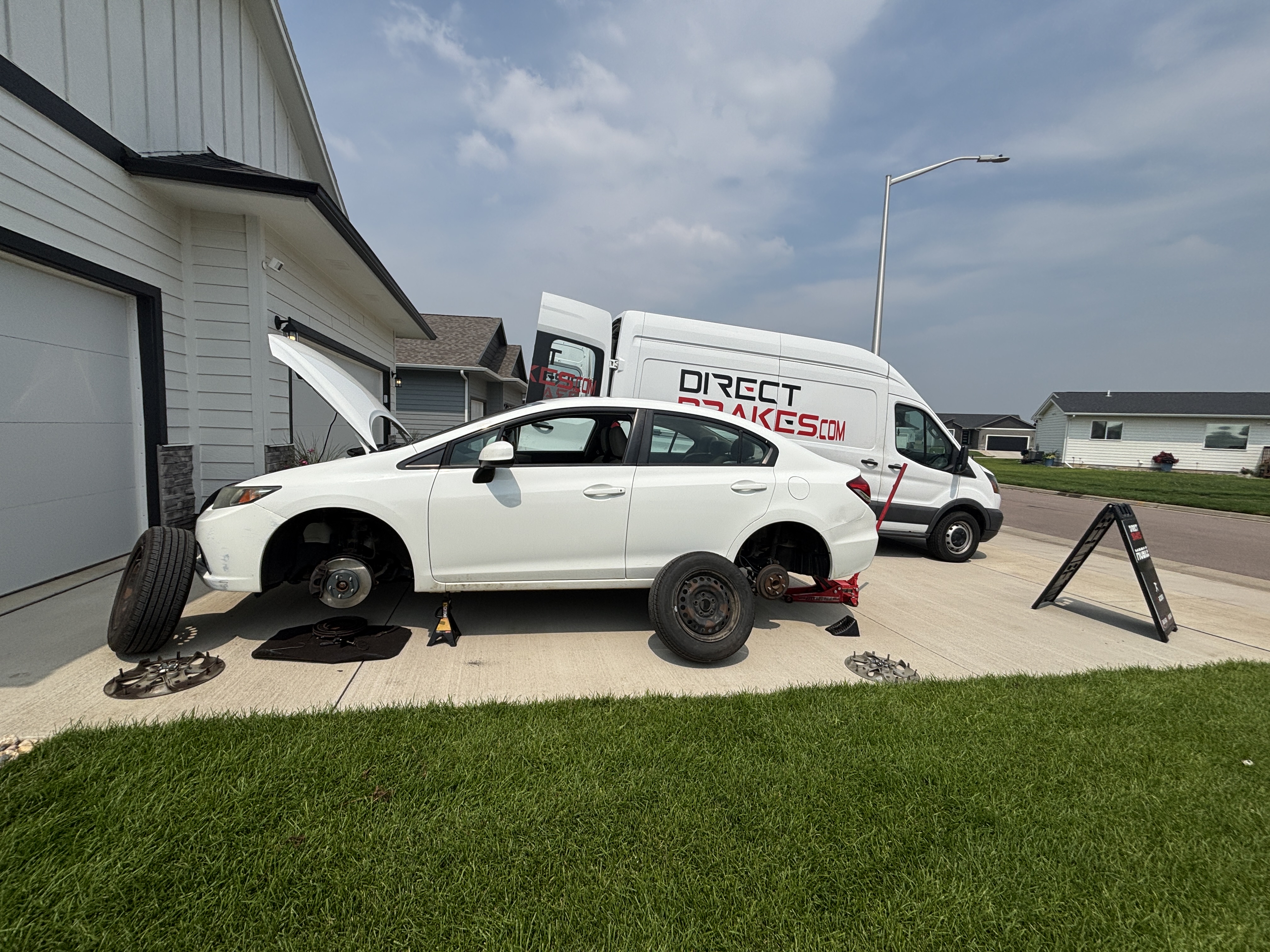 Certified brake technician replacing brake pads on vehicle in Sioux Falls South Dakota