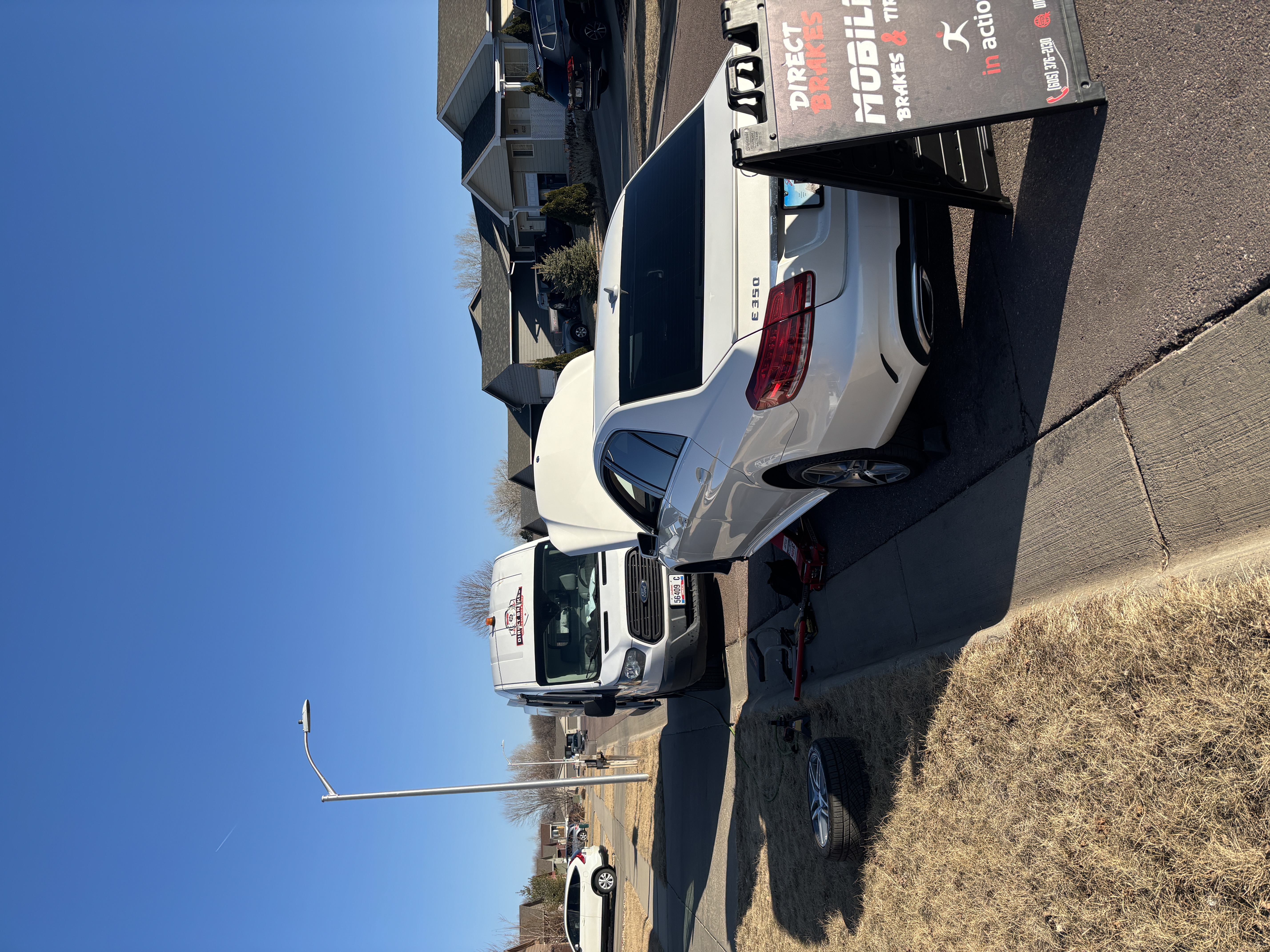 Direct Brakes technician installing battery in GMC Sierra