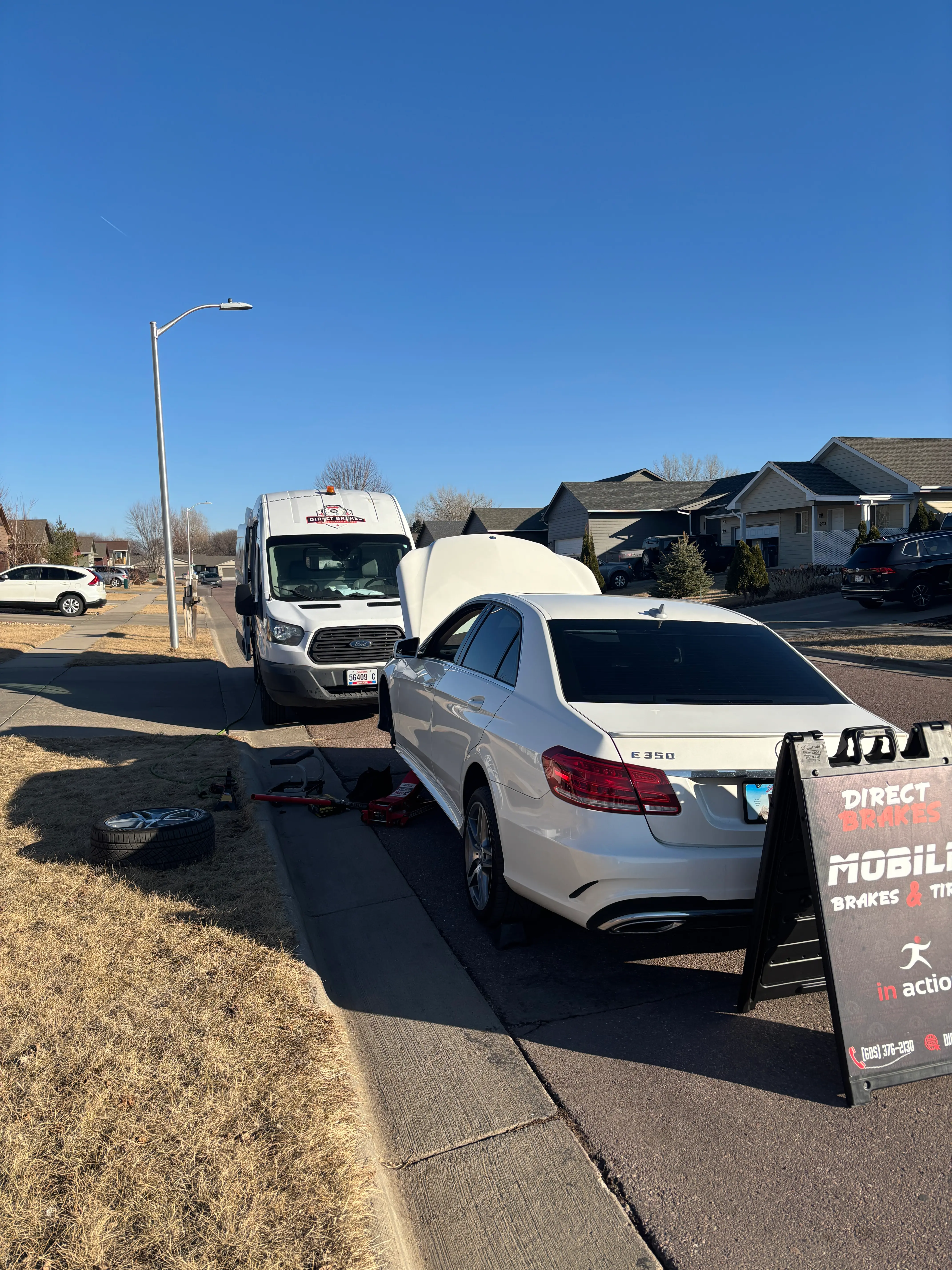 Direct Brakes technician installing battery in GMC Sierra