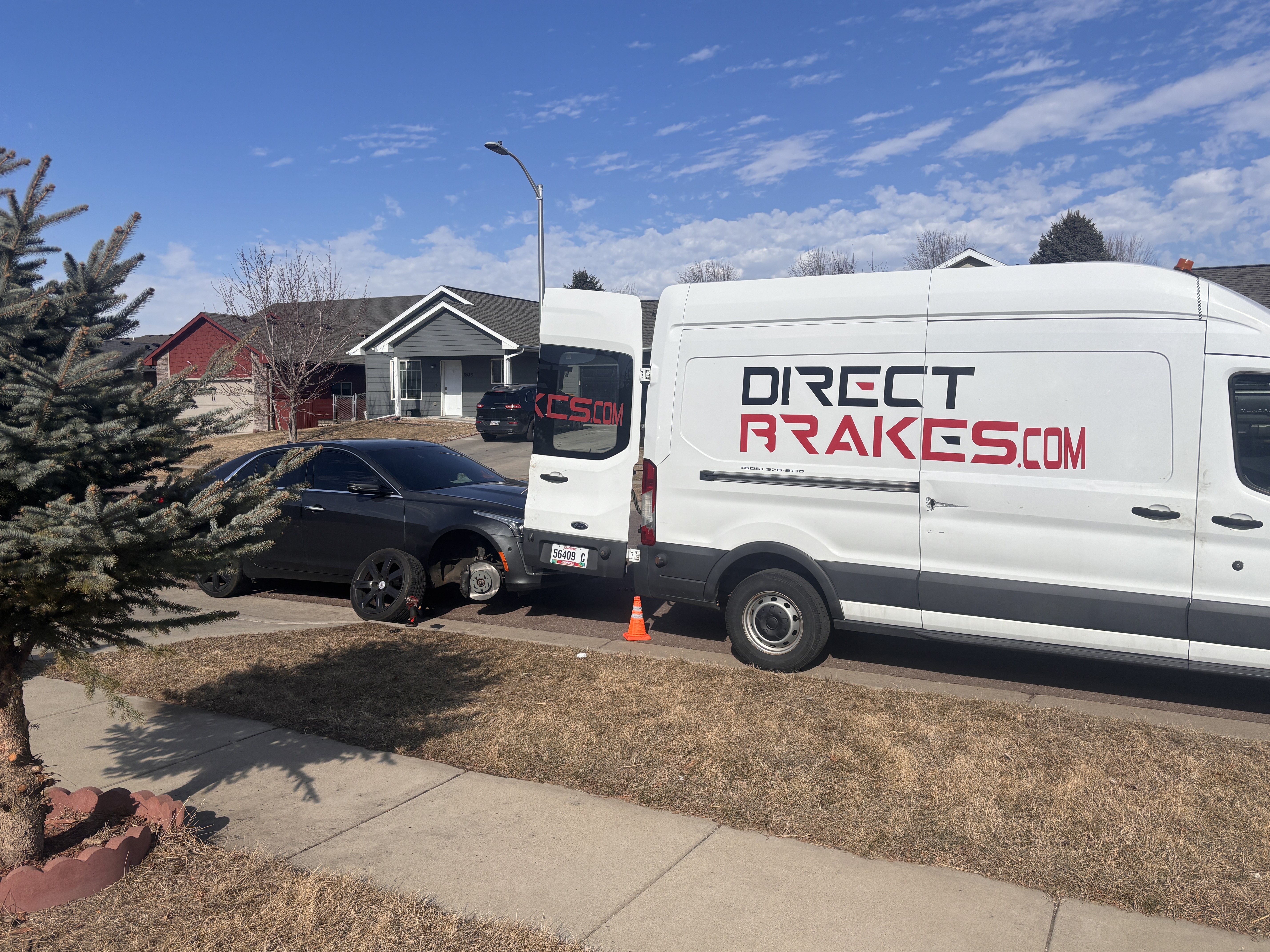 Mechanic replacing brake pads and rotors on a vehicle
