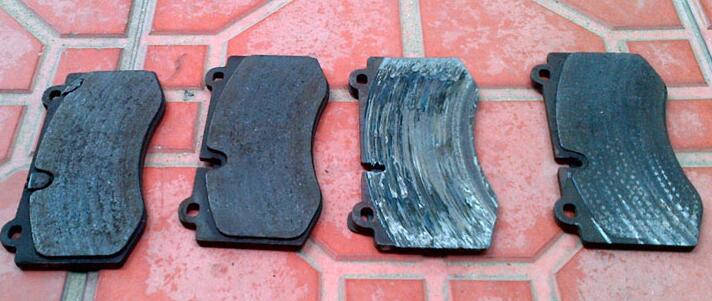 New vs worn brake pads side by side showing thickness difference — brake pad lifespan comparison