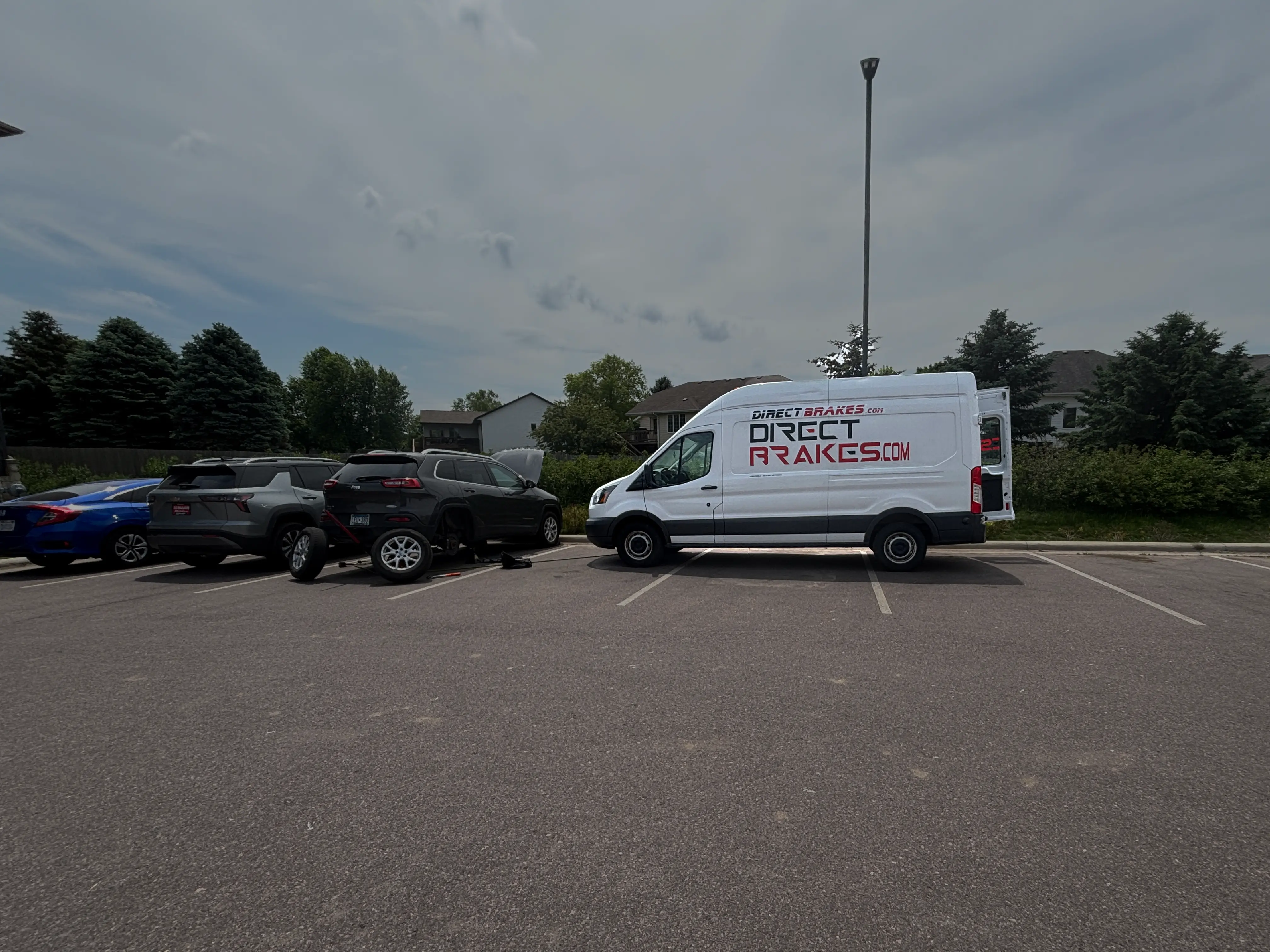 Mobile brake repair technician servicing vehicle in Tea SD driveway