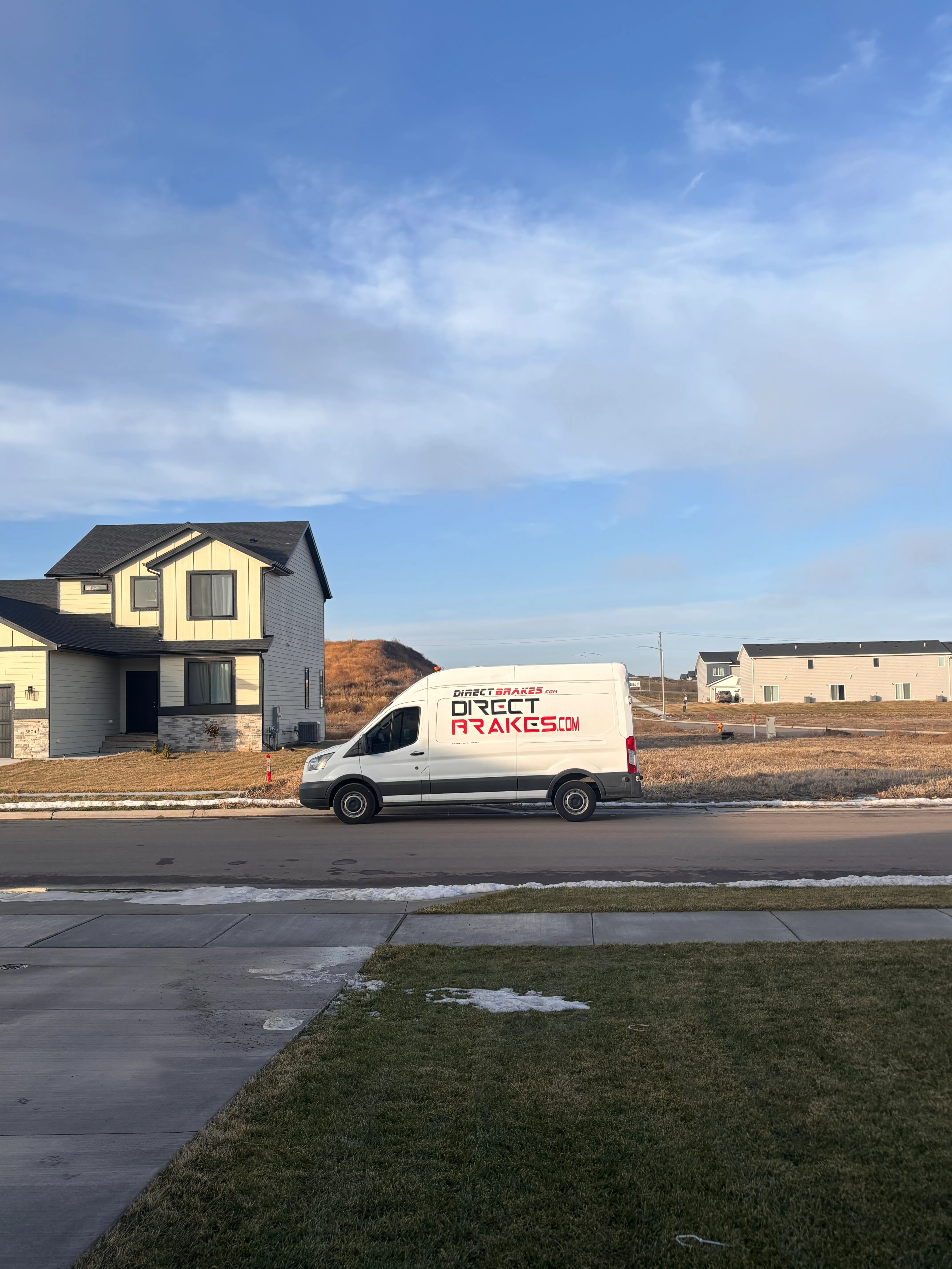 Premium brake pads being installed on vehicle rotor in Omaha Nebraska