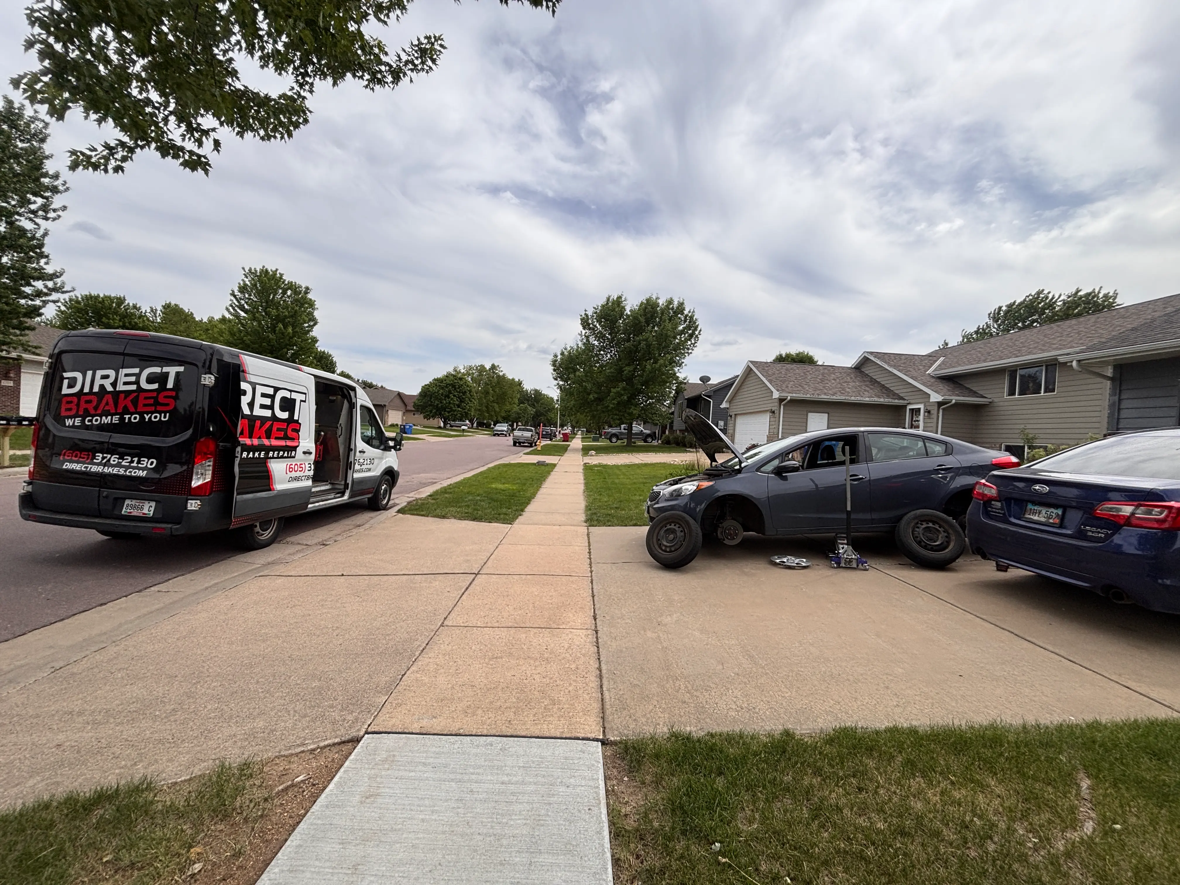 Direct Brakes technician performing mobile brake repair in Omaha driveway